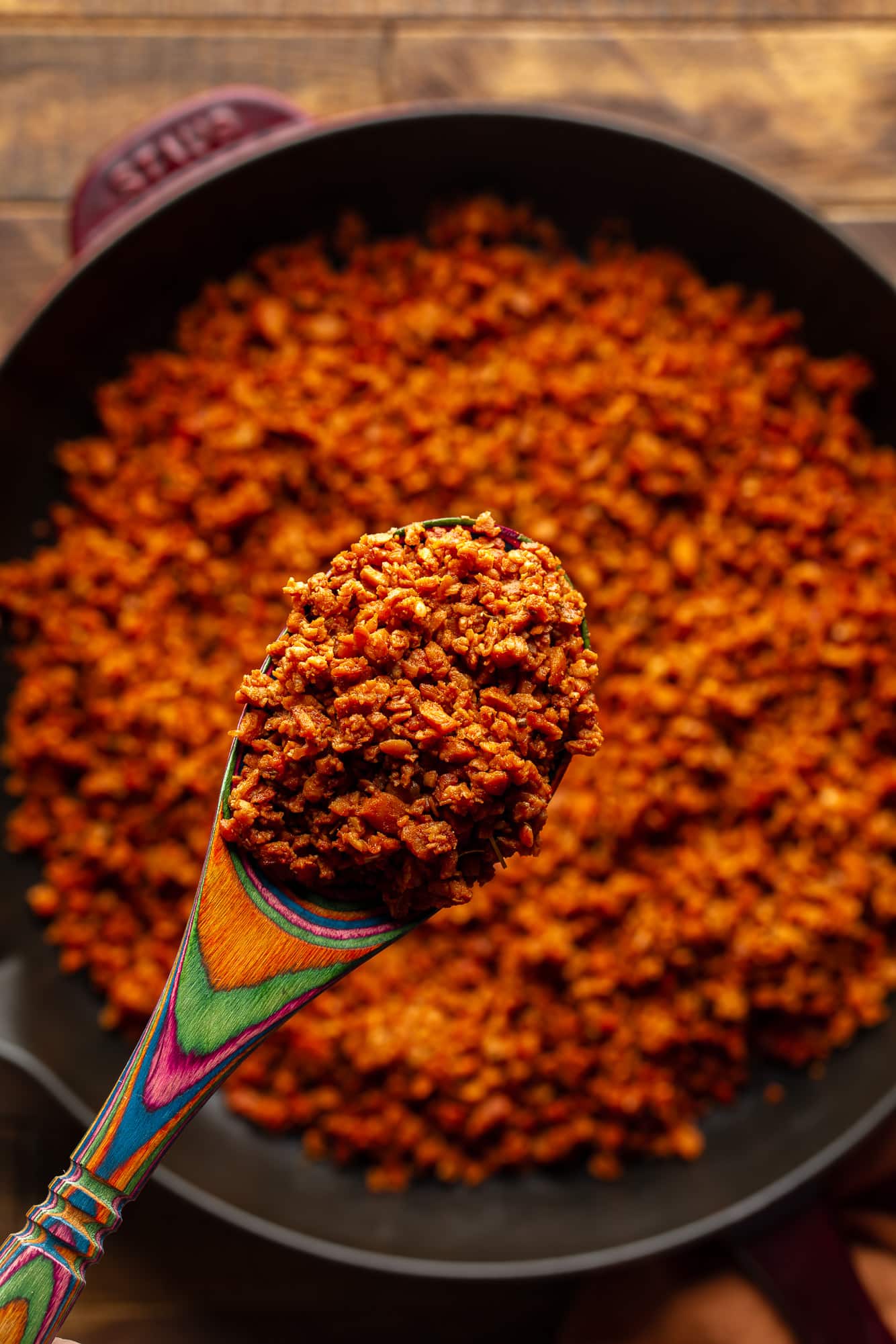 First in a wooden spoon that holds a vegan chorizo ​​spoon.